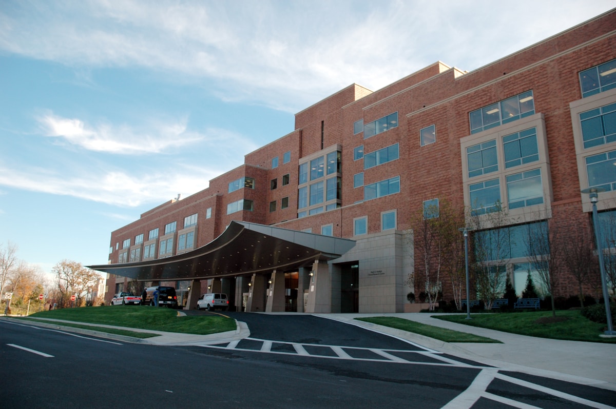 Bright modern hospital corridor with clinical staff